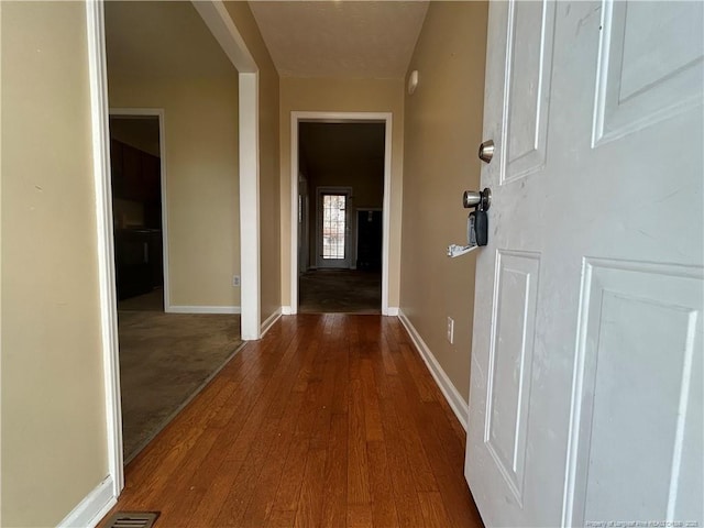 hall with hardwood / wood-style floors