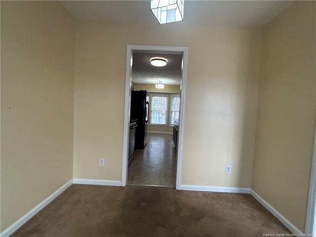 hallway with dark colored carpet