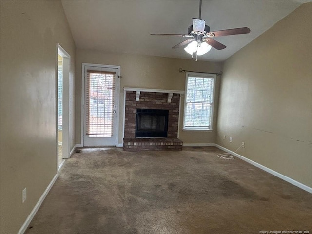 unfurnished living room featuring lofted ceiling, a fireplace, ceiling fan, and carpet