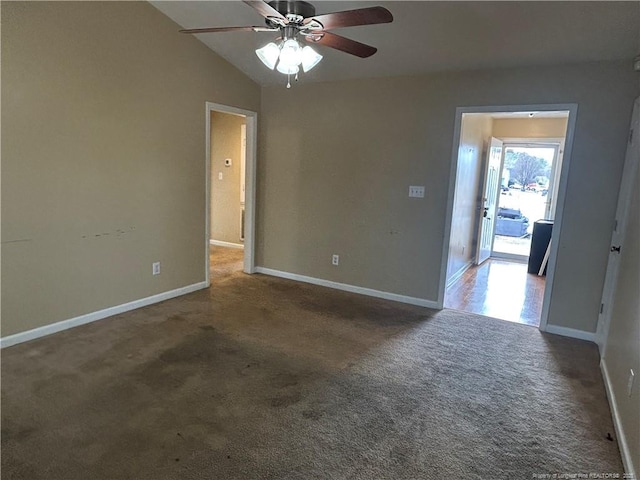 carpeted empty room with vaulted ceiling and ceiling fan