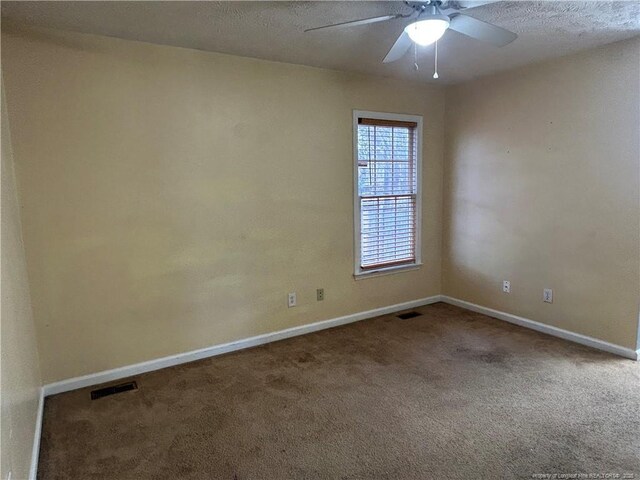 carpeted empty room with a textured ceiling and ceiling fan