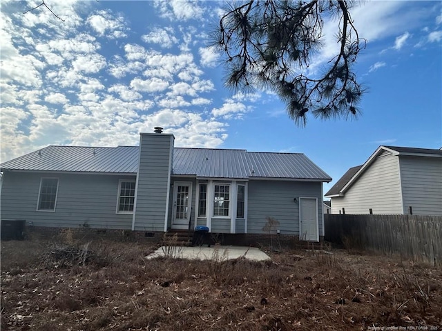 rear view of house with central AC unit