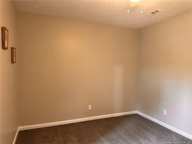 unfurnished room with carpet flooring and a textured ceiling