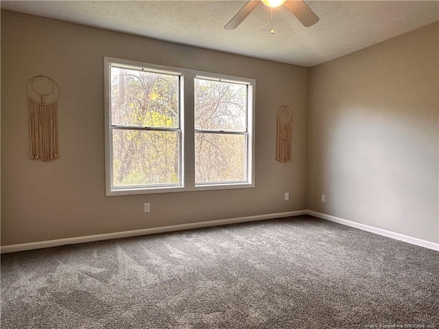 carpeted spare room with ceiling fan and a textured ceiling