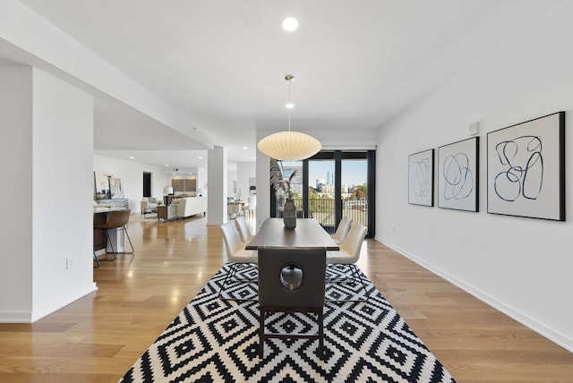 dining area featuring light wood-type flooring