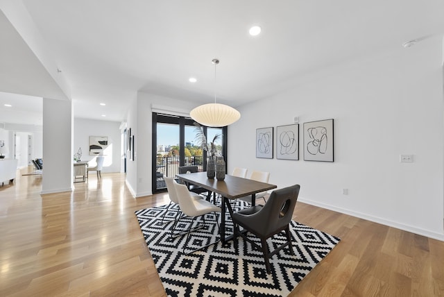 dining space with light hardwood / wood-style flooring