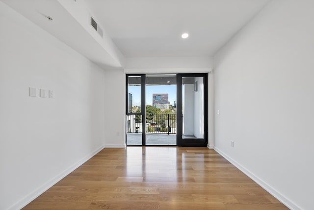 unfurnished room with light hardwood / wood-style flooring