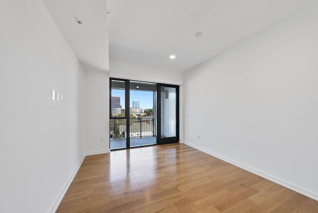 empty room with light hardwood / wood-style flooring