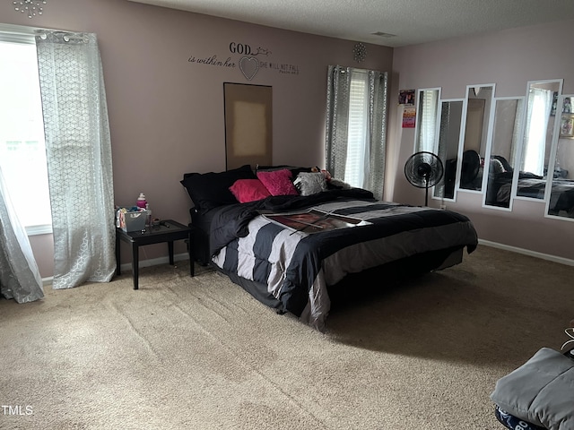 bedroom with carpet and a textured ceiling