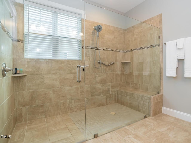 full bathroom with baseboards and a stall shower