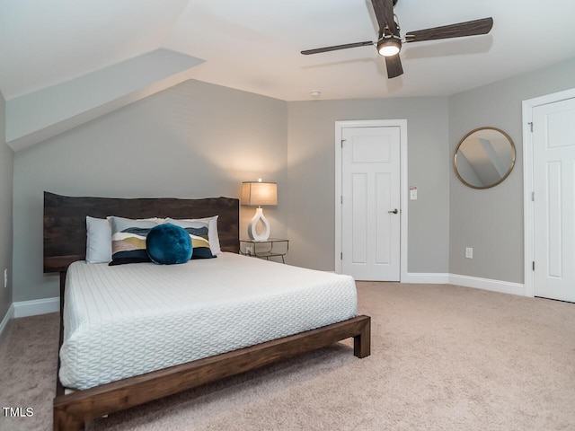 bedroom with vaulted ceiling, a ceiling fan, baseboards, and carpet floors