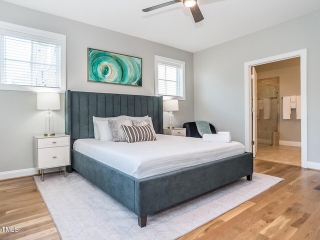 bedroom featuring ceiling fan, ensuite bathroom, baseboards, and wood finished floors