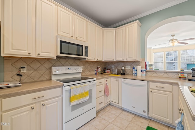 kitchen with ceiling fan, light tile patterned floors, white appliances, light countertops, and backsplash