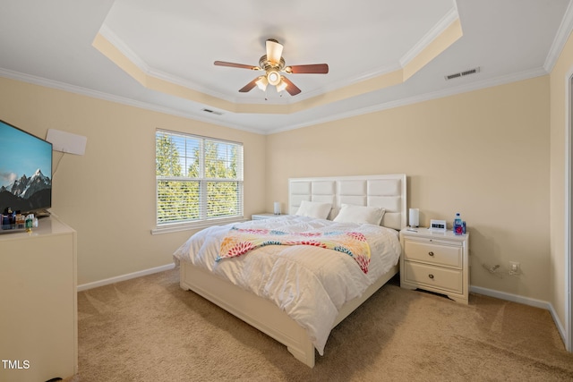 bedroom with a raised ceiling, visible vents, light carpet, and baseboards