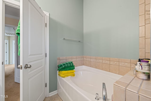 bathroom with ornamental molding and a garden tub