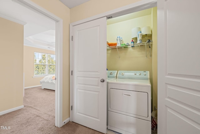 laundry area with light carpet, laundry area, baseboards, and washer and dryer