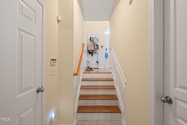 staircase featuring tile patterned floors