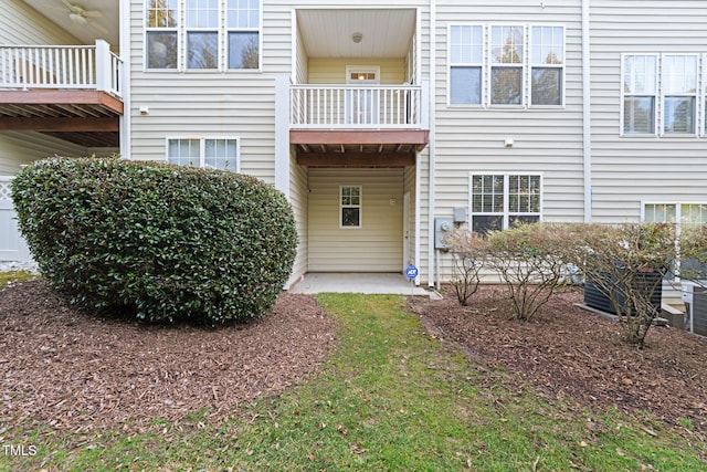 back of house featuring central AC unit and a balcony