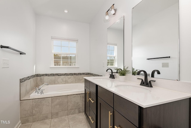 full bath featuring a sink, a bath, tile patterned flooring, and double vanity