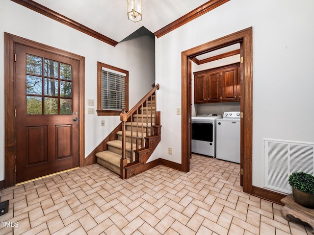 entrance foyer with baseboards, visible vents, crown molding, and independent washer and dryer