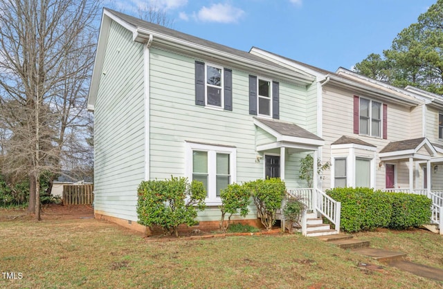 view of front of home with a front yard and crawl space