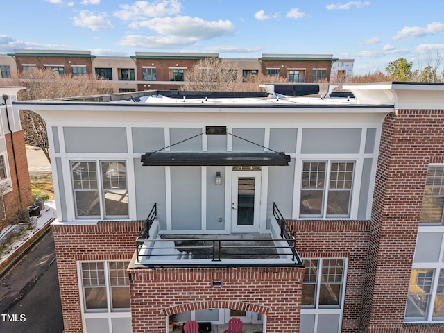 rear view of house with brick siding