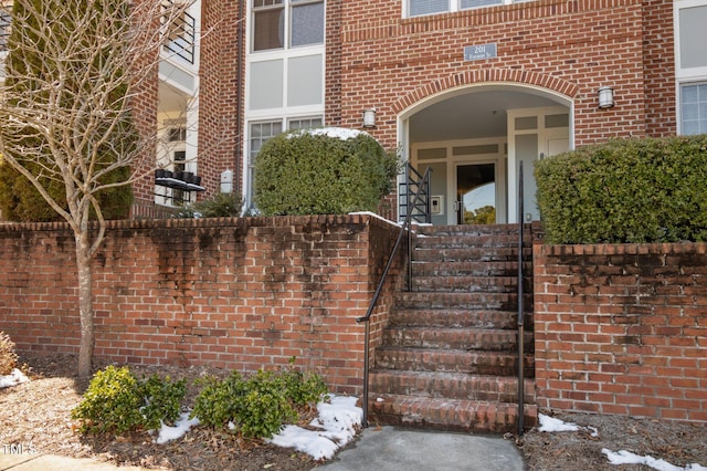 doorway to property with brick siding