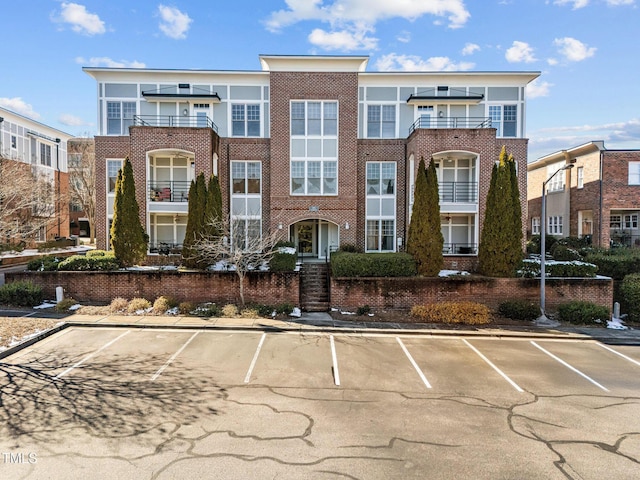 view of building exterior with uncovered parking