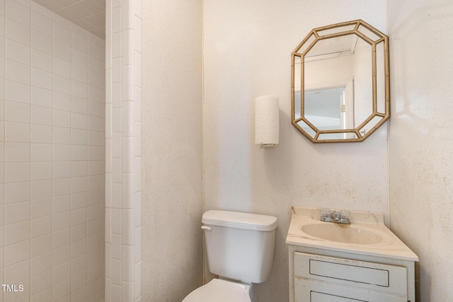 bathroom featuring toilet and vanity