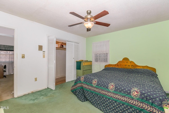 bedroom with carpet, a closet, ceiling fan, and a textured ceiling