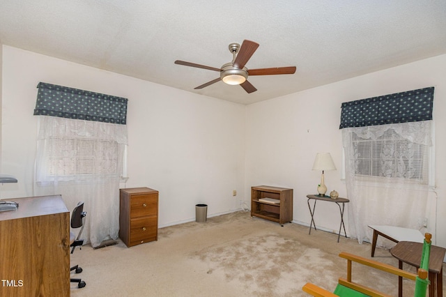 interior space with ceiling fan, a textured ceiling, and carpet flooring