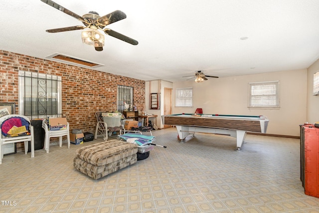 rec room with ceiling fan, brick wall, billiards, and baseboards