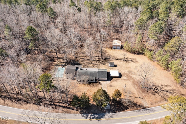 drone / aerial view with a wooded view