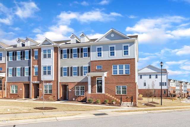 multi unit property featuring a residential view and brick siding