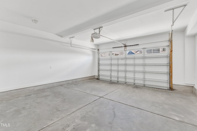 garage with baseboards and a garage door opener