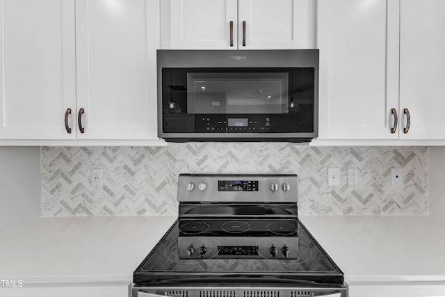 kitchen with appliances with stainless steel finishes, white cabinets, and light countertops