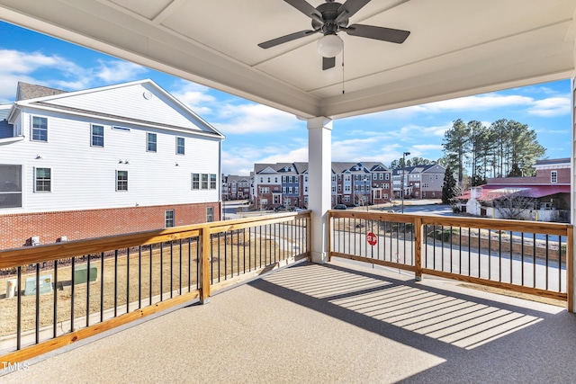 view of patio / terrace featuring ceiling fan and a residential view