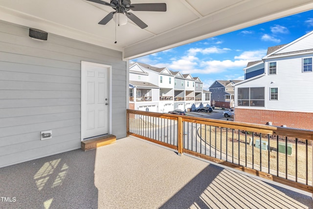 wooden deck featuring a residential view and a ceiling fan