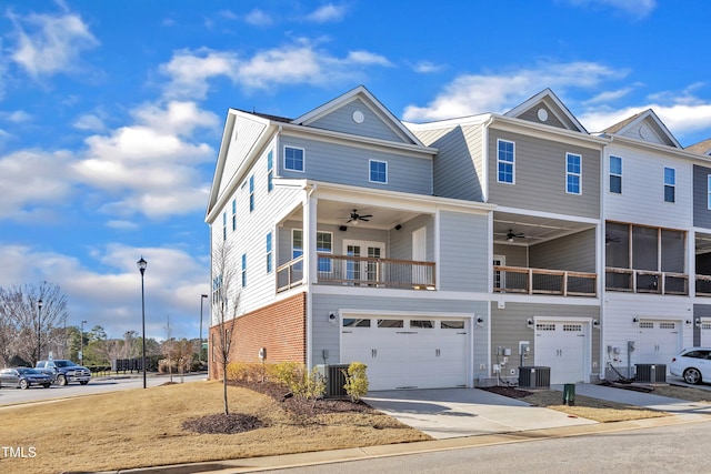 townhome / multi-family property featuring concrete driveway, central AC, ceiling fan, and a balcony