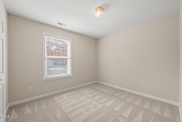 unfurnished room featuring light carpet, baseboards, and visible vents