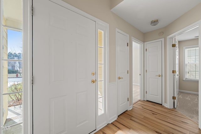 entryway featuring light wood finished floors and baseboards