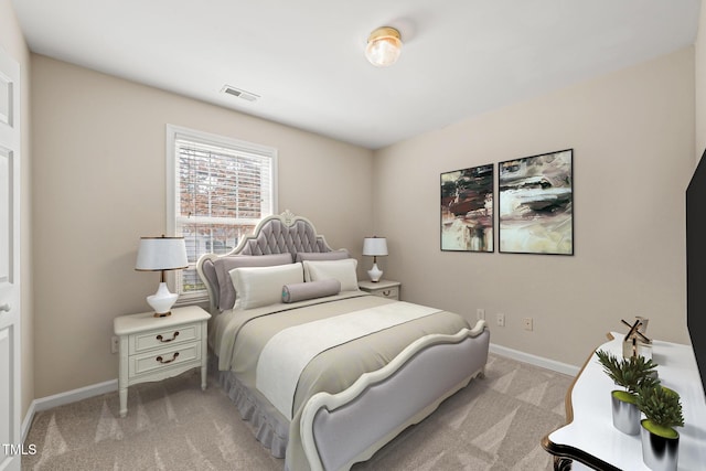 bedroom with baseboards, visible vents, and light colored carpet