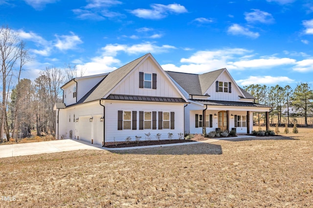 modern inspired farmhouse with a porch, concrete driveway, board and batten siding, a front yard, and a standing seam roof