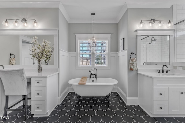 bathroom featuring wainscoting, ornamental molding, a soaking tub, and vanity