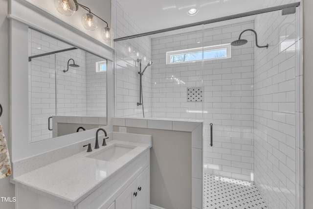 full bathroom featuring a stall shower and vanity