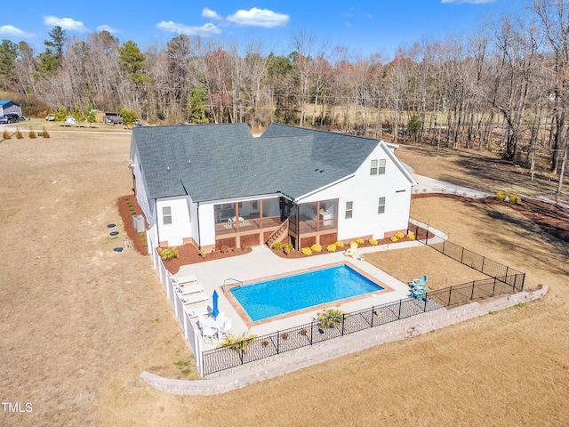 view of swimming pool with a fenced in pool, a fenced backyard, a patio, and a lawn