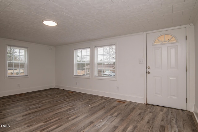 entryway featuring ornamental molding and dark wood-type flooring