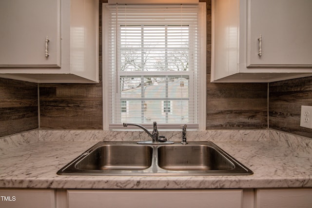 kitchen with plenty of natural light, sink, and white cabinets