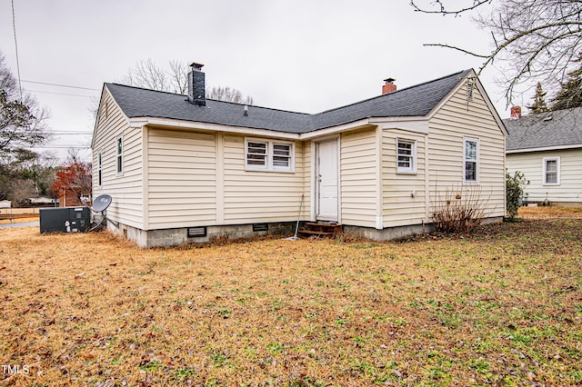 rear view of property with a lawn