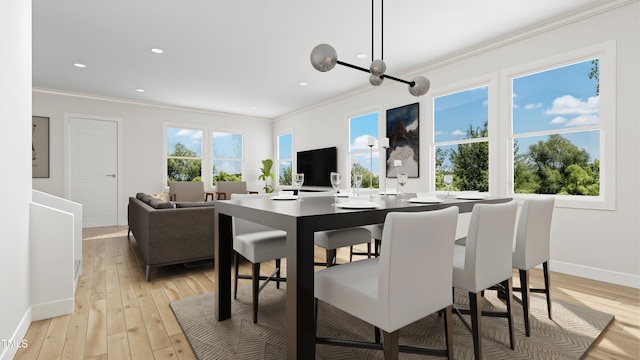 dining room with crown molding and light wood-type flooring